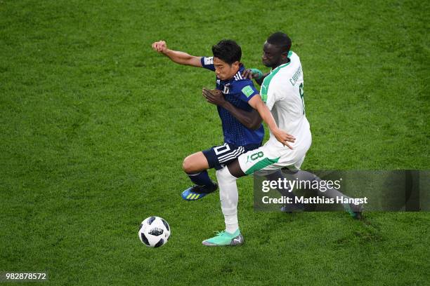 Shinji Kagawa of Japan is rought down by Cheikhou Kouyate of Senegal of Senegal during the 2018 FIFA World Cup Russia group H match between Japan and...