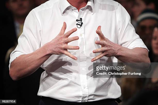 Conservative party leader David Cameron rolls up his shirt sleeves as he speaks to party faithful at Leeds City Museum as the Tory election campaign...