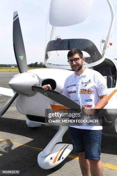 Gerald Egea poses next to his plane at Bergerac airport on June 24, 2018 after landing for a last refueling before a 45 mn flight to Rodez to end his...