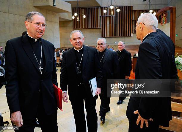 Cardinal Roger Mahony walks with his successor, San Antonio, Texas Archbishop Jose Gomez , after a news conference at Cathedral of Our Lady of the...