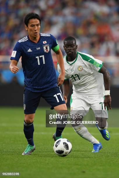 Japan's midfielder Makoto Hasebe vies with Senegal's midfielder Papa Alioune Ndiaye during the Russia 2018 World Cup Group H football match between...