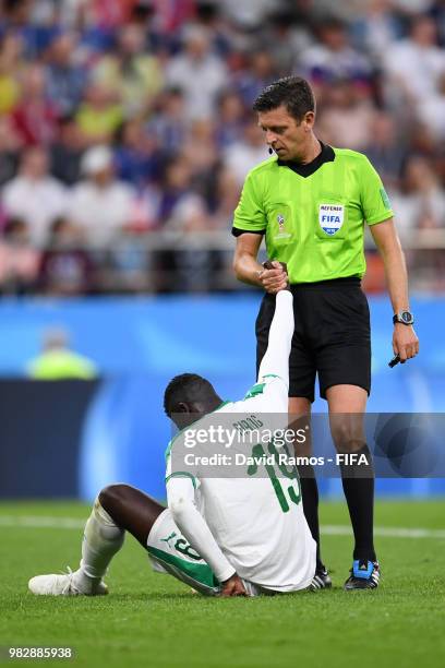 Referee Gianluca Rocchi helps up Mbaye Niang of Senegal during the 2018 FIFA World Cup Russia group H match between Japan and Senegal at Ekaterinburg...