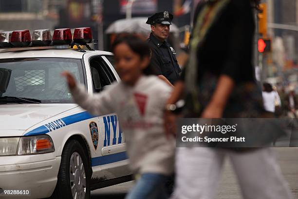 New York City police officer stands on patrol on April 6, 2010 in New York City. Following a melee involving groups of youths around Times Square...