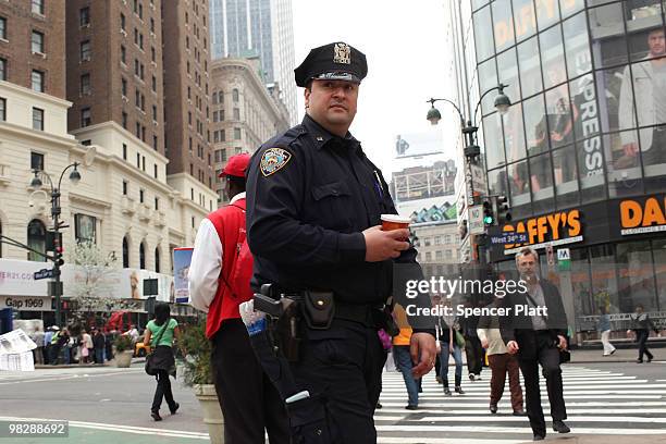 New York City police officer stands on patrol on April 6, 2010 in New York City. Following a melee involving groups of youths around Times Square...