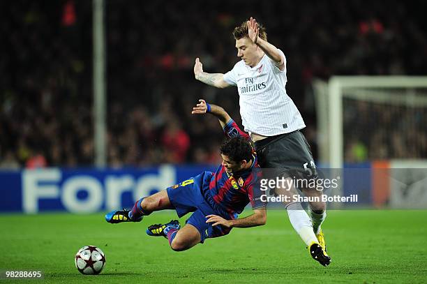 Rafael Márquez of Barcelona is challenged by Nicklas Bendtner of Arsenal during the UEFA Champions League quarter final second leg match between...