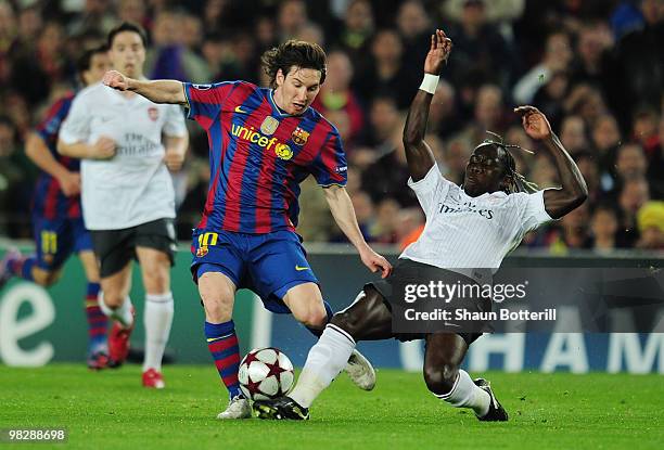 Lionel Messi of Barcelona is challenged by Bacary Sagna of Arsenal during the UEFA Champions League quarter final second leg match between Barcelona...