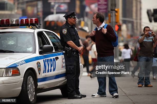 New York City police officer stands on patrol on April 6, 2010 in New York City. Following a melee involving groups of youths around Times Square...