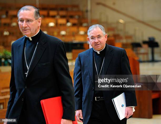 Cardinal Roger Mahony and his successor, San Antonio, Texas Archbishop Jose Gomez, arrive for a news conference at the Cathedral of Our Lady of the...