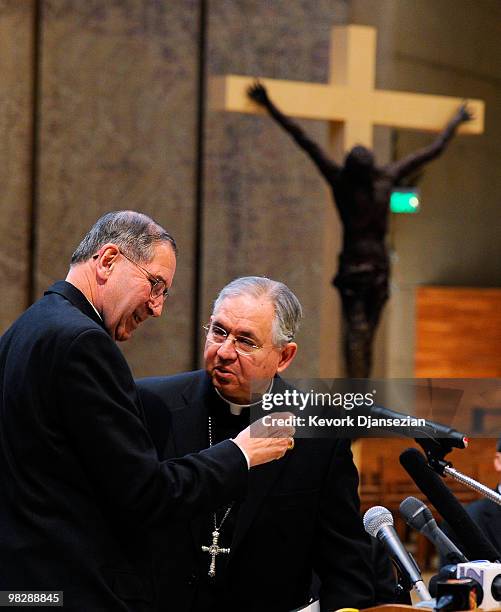 Cardinal Roger Mahony talks with his successor, San Antonio, Texas Archbishop Jose Gomez , during a news conference at the Cathedral of Our Lady of...