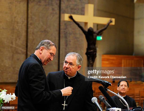 Cardinal Roger Mahony talks with his successor, San Antonio, Texas Archbishop Jose Gomez , during a news conference at the Cathedral of Our Lady of...