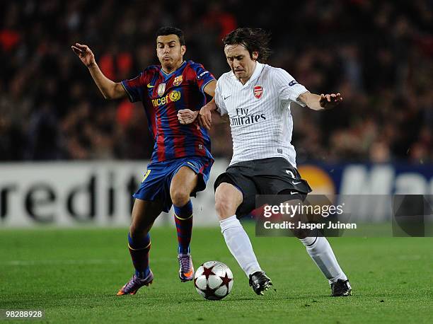 Pedro of Barcelona is challenged by Tomas Rosicky of Arsenal during the UEFA Champions League quarter final second leg match between Barcelona and...