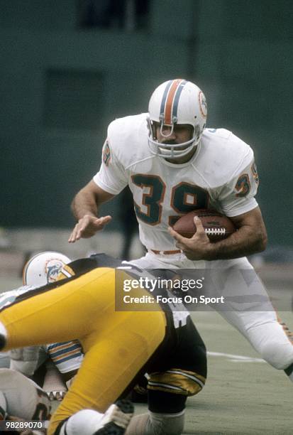 S: Running back Larry Csonka of the Miami Dolphins carries the ball against the Pittsburgh Steelers circa mid 1970's during an NFL football game at...