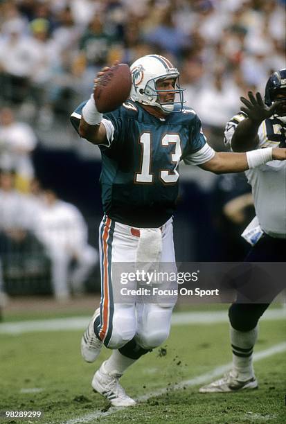 S: Quarterback Dan Marino of the Miami Dolphins rolls out to pass against the San Diego Chargers circa late 1980's during an NFL football game at Joe...