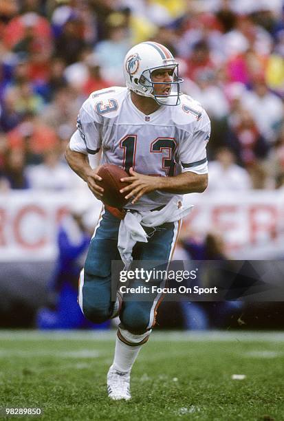 Quarterback Dan Marino of the Miami Dolphins rolls out to pass circa mid 1990's during an NFL football game. Marino played for the Dolphins from...