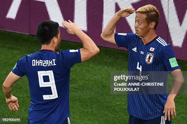 Japan's midfielder Keisuke Honda celebrates a goal with Japan's forward Shinji Okazaki during the Russia 2018 World Cup Group H football match...