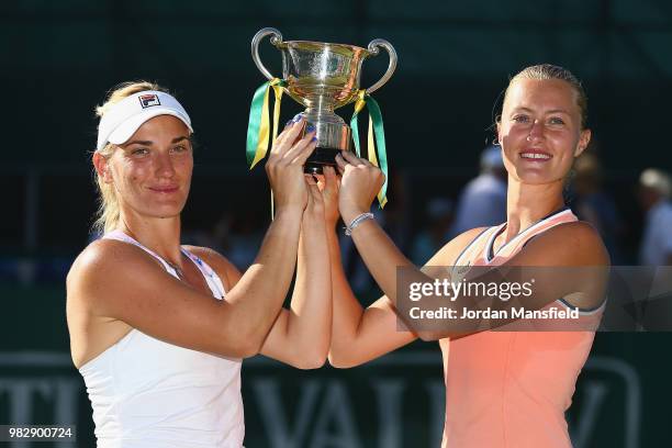 Timea Babos of Hungary and Kristina Mladenovic of France pose with the Trophy after their victory during their doubles Final match against Elise...