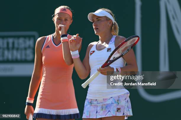Kristina Mladenovic of France and Timea Babos of Hungary talk tactics during their doubles Final match against Elise Mertens of Belgium and Demi...