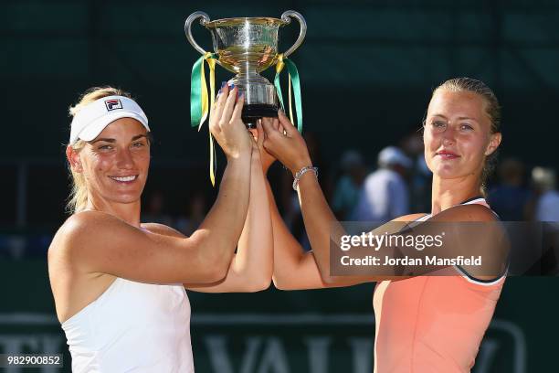 Timea Babos of Hungary and Kristina Mladenovic of France pose with the Trophy after their victory during their doubles Final match against Elise...
