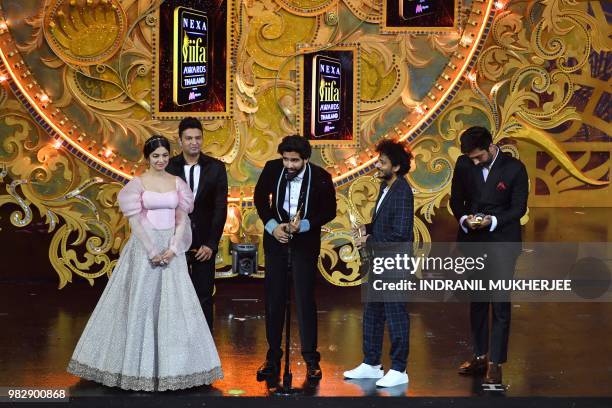 Amaal Malik , Tanishk Bagchi and Akhil Sachdeva receive the award for Best Music Direction from Bollywood actress Divya Khosla Kumar and producer...