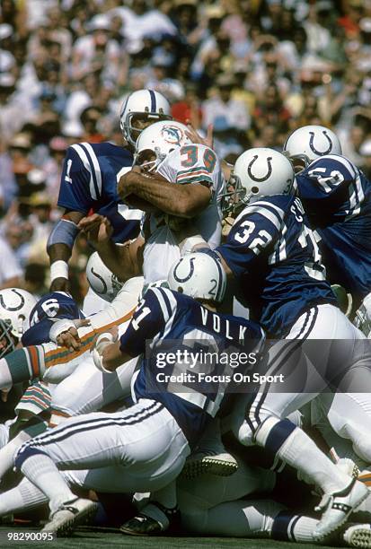S: Running back Larry Csonka of the Miami Dolphins in action is hit by linebacker Mike Curtis and defensive back Rick Volk of the Baltimore Colts...