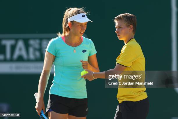 Elise Mertens of Belgium and Demi Schuurs of the Netherlands talk tactics during their doubles Final match against Kristina Mladenovic of France and...