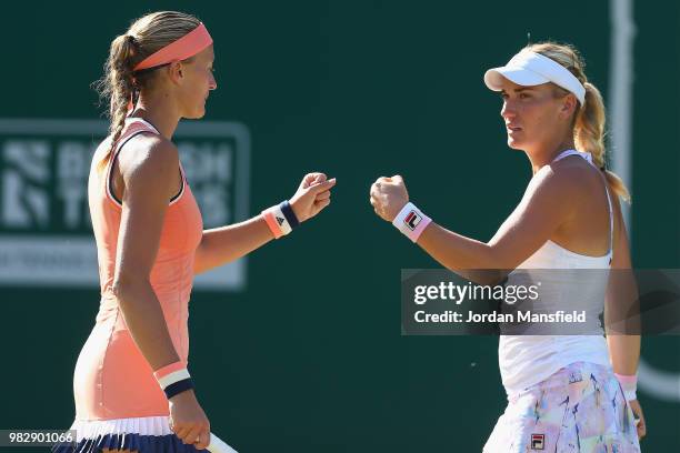 Kristina Mladenovic of France and Timea Babos of Hungary talk tactics during their doubles Final match against Elise Mertens of Belgium and Demi...