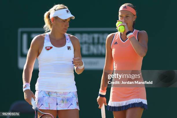 Kristina Mladenovic of France and Timea Babos of Hungary talk tactics during their doubles Final match against Elise Mertens of Belgium and Demi...