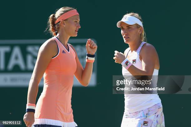 Kristina Mladenovic of France and Timea Babos of Hungary talk tactics during their doubles Final match against Elise Mertens of Belgium and Demi...