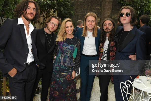 Joanne Froggatt poses with Charlie Salt, Joe Donovan, Myles Kellock, Josh Dewhurst and Tom Ogden of Blossoms, all wearing Paul Smith, at the Paul...