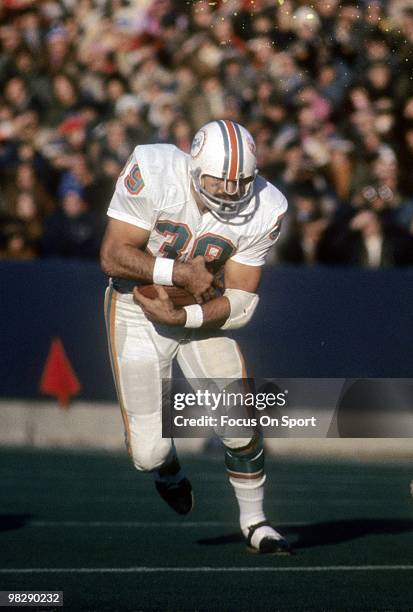 S: Running back Larry Csonka of the Miami Dolphins carries the ball against the New England Patriots circa mid 1970's during an NFL football game at...