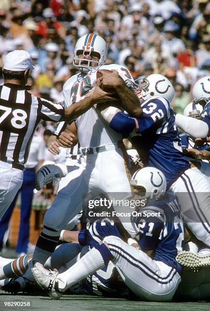 S: Running back Larry Csonka of the Miami Dolphins in action is hit by linebacker Mike Curtis and defensive back Rick Volk of the Baltimore Colts...