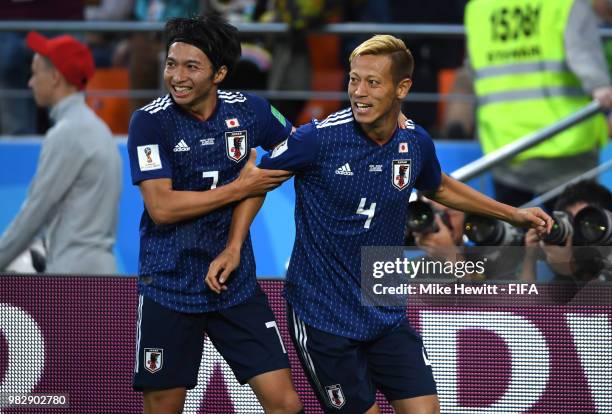 Keisuke Honda of Japan celebrates with teammate Gaku Shibasaki after scoring his team's second goal during the 2018 FIFA World Cup Russia group H...