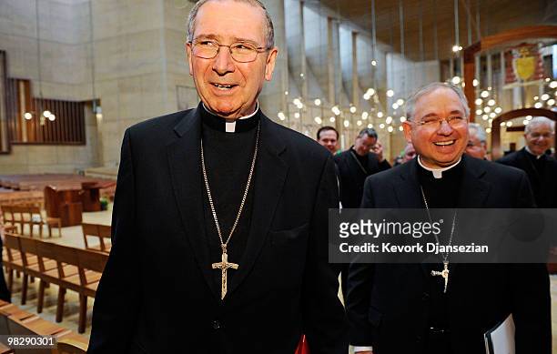 Cardinal Roger Mahony walks with his successor, San Antonio, Texas Archbishop Jose Gomez , after a news conference at the Cathedral of Our Lady of...