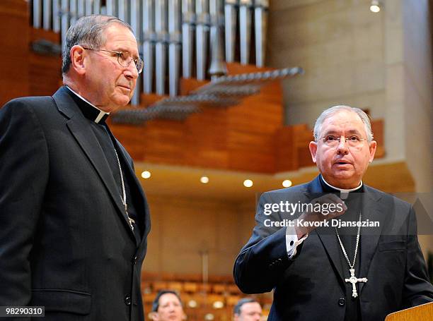 Cardinal Roger Mahony listens as his successor, San Antonio, Texas Archbishop Jose Gomez, during a news conference at the Cathedral of Our Lady of...