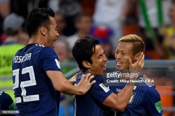 Keisuke Honda of Japan celebrates with teammate Makoto Hasebe of Japan and Maya Yoshida after scoring his team's second goal during the 2018 FIFA...
