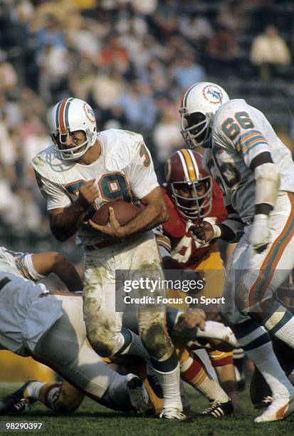 Running back Larry Csonka of the Miami Dolphins carries the ball against the Washington Redskins January 14, 1973 during Super Bowl VII at the Los...