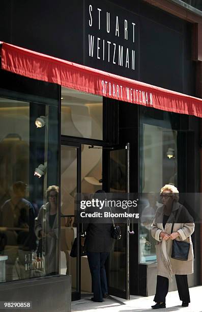 Pedestrians walk past a Stuart Weitzman designer shoe store on Madison Avenue in New York, U.S., on Tuesday, April 6, 2010. Shoe designer Stuart...