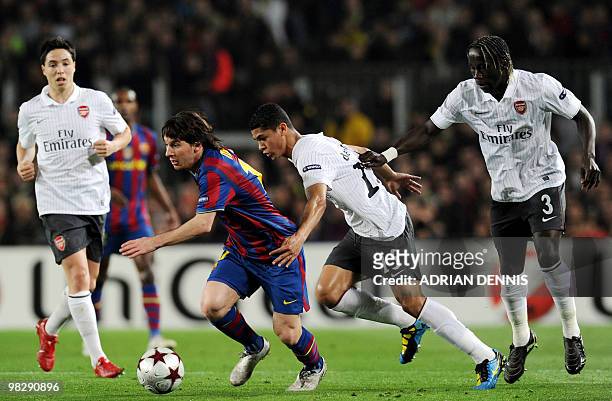 Barcelona's Argentinian forward Lionel Messi runs with the ball chased by Arsenal's Samir Nasri , Denilson and Bacary Sagna during the Champions...