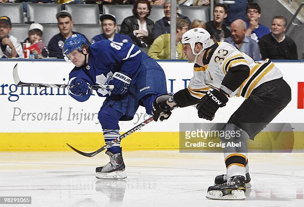 Phil Kessel of the Toronto Maple Leafs shoots the puck as Zdeno Chara of the Boston Bruins defends during the game on April 3, 2010 at the Air Canada...