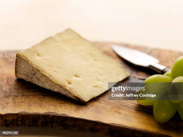 cheese on cutting board - jeffrey coolidge stock-fotos und bilder