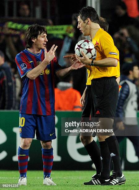 Barcelona's Argentinian forward Lionel Messi gestures to get the ball from German Referee Wolfgang Stark at the end of the game against Arsenal...