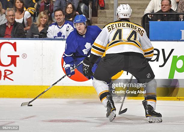 Phil Kessel of the Toronto Maple Leafs looks to pass the puck as Dennis Seidenberg of the Boston Bruins defends during the game on April 3, 2010 at...