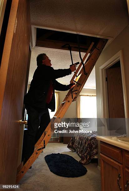 Arapahoe County sheriff's deputy Jim Osborn searches an attic while supervising an eviction on April 6, 2010 in Aurora, Colorado. The tenants had...