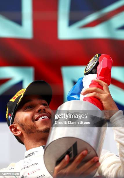 Race winner Lewis Hamilton of Great Britain and Mercedes GP celebrates on the podium during the Formula One Grand Prix of France at Circuit Paul...