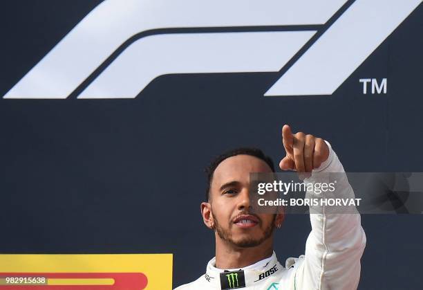 Winner Mercedes' British driver Lewis Hamilton celebrates on the podium after the Formula One Grand Prix de France at the Circuit Paul Ricard in Le...