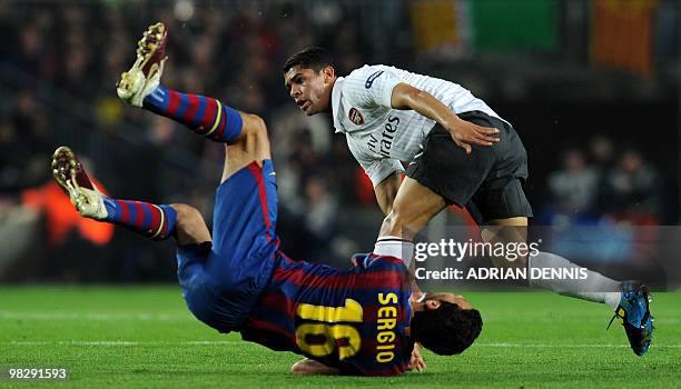 Arsenal's Brazilian midfielder Denilson collides with Barcelona's midfielder Sergio Busquets during the Champions League quarter-final second-leg...