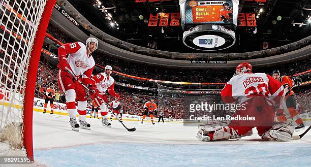 Niklas Kronwall, Henrik Zetterberg and Chris Osgood of the Detroit Red Wings stop a scoring attempt by Danny Briere of the Philadelphia Flyers on...