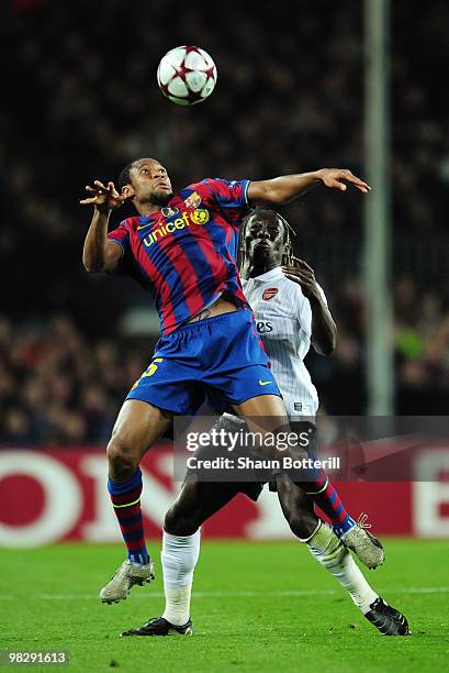 Seydou Keita of Barcelona is challenged by Bacary Sagna of Arsenal during the UEFA Champions League quarter final second leg match between Barcelona...