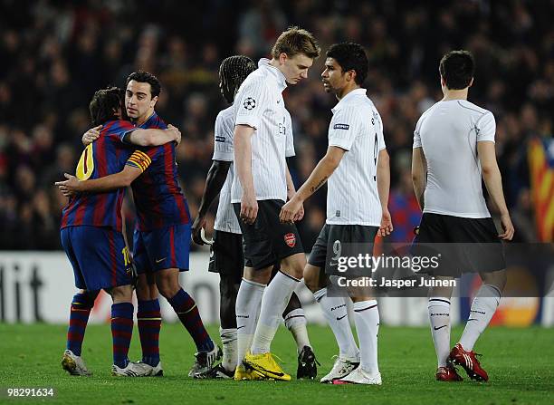 Lionel Messi of Barcelona celebrates as Nicklas Bendtner and Eduardo of Arsenal look dejected after the UEFA Champions League quarter final second...