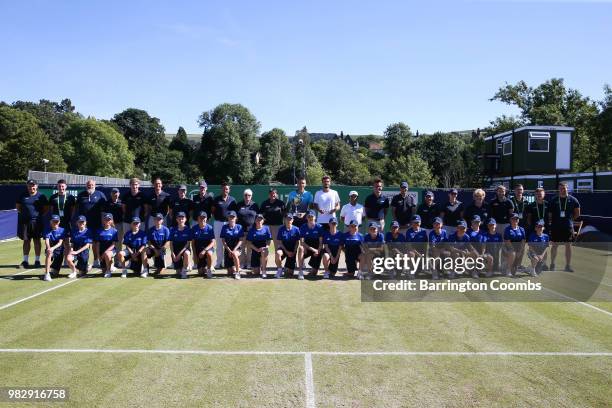 Sergiy Stakhovsky of the Ukraine and Oscar Otte of Germany pose with the ground staff and ball boys after the Men's final between Sergiy Stakhovsky...